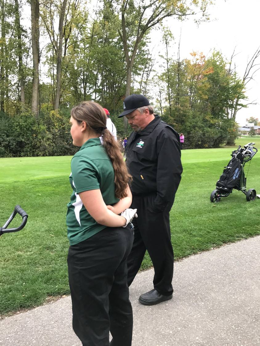 Courtney & Coach Mike talk over strategy on the first playoff hole.
