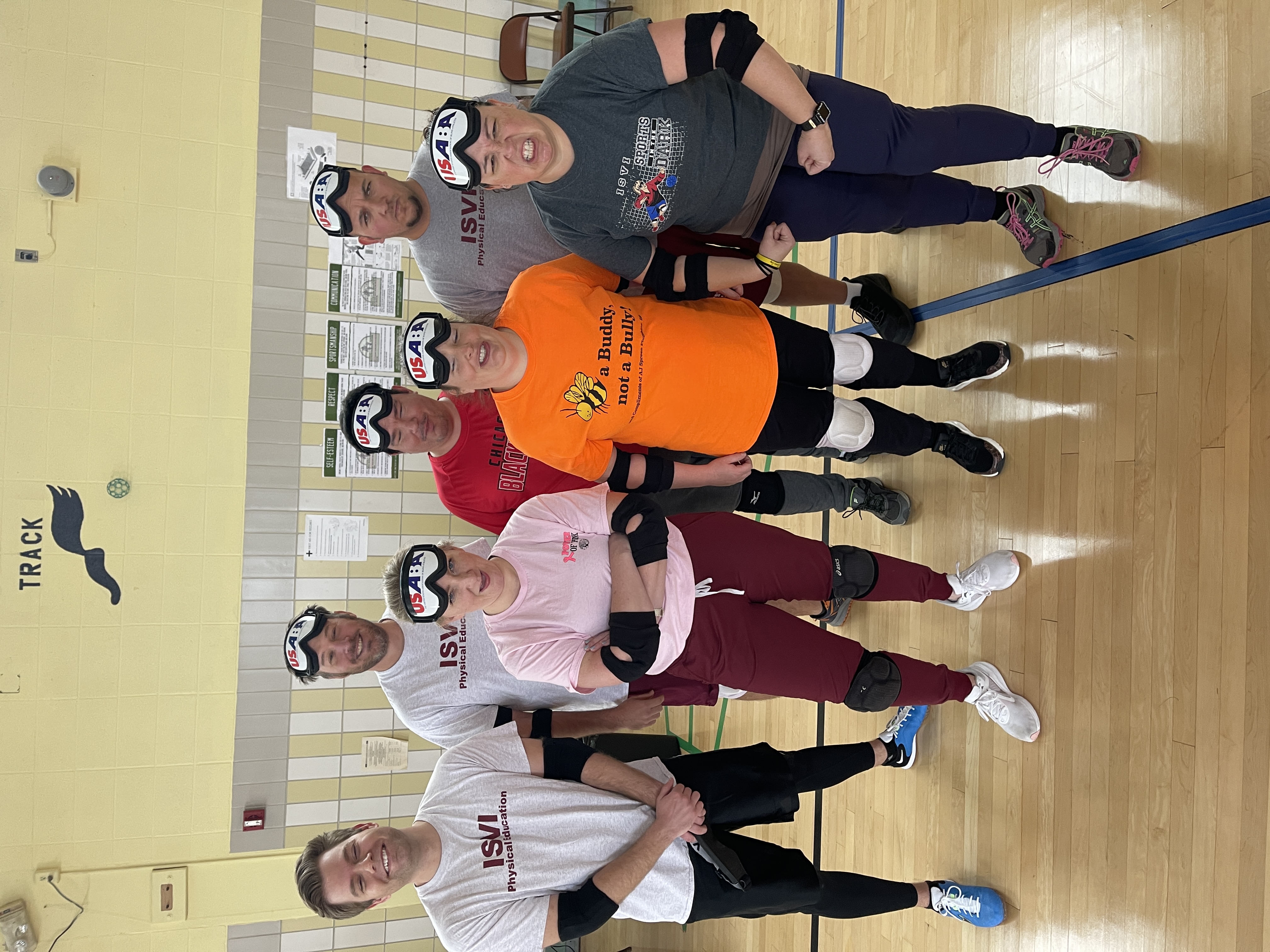 7 Staff members pose for a picture at the Staff vs Students game