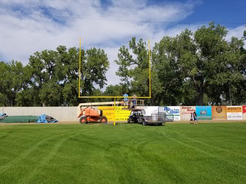 Setting up goal posts after the baseball season. August, 2017