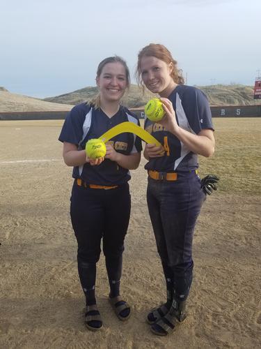 Josie Chapweske and McKaylla Hudson with their homerun balls. They are also holding 