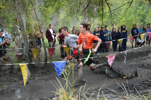 LHS male runner running through mud