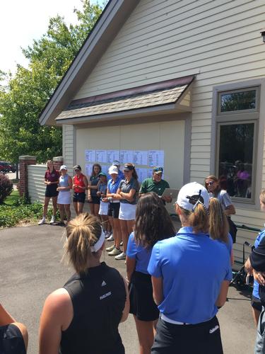 Ryann Breslin receiving a medal for placing 2nd overall at the season opening tournament at Grand Valley's course, The Meadows.